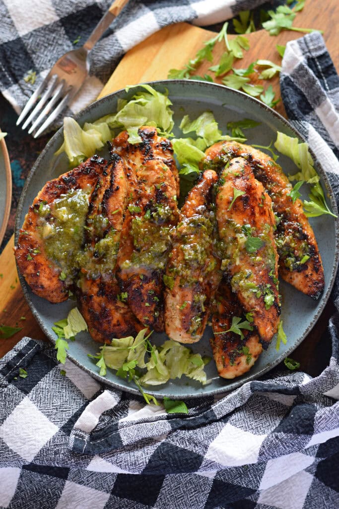 Honey Dijon chicken tenders on a plate with a sauce.