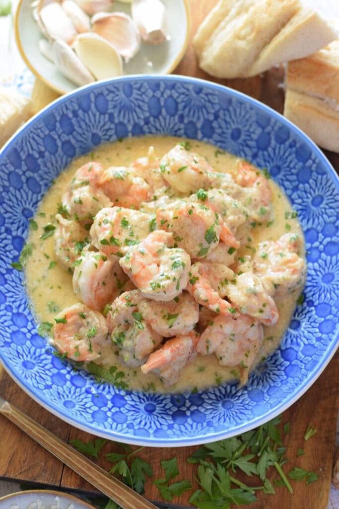 Creamy garlic shrimp in a blue bowl.