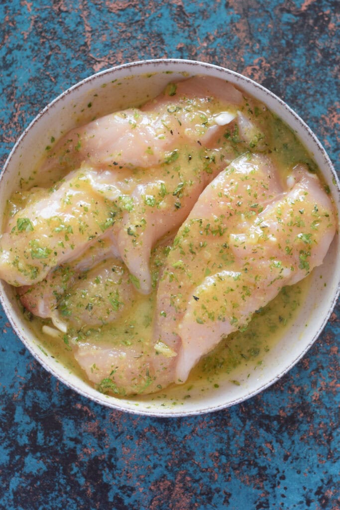 Chicken tenders in a marinade.