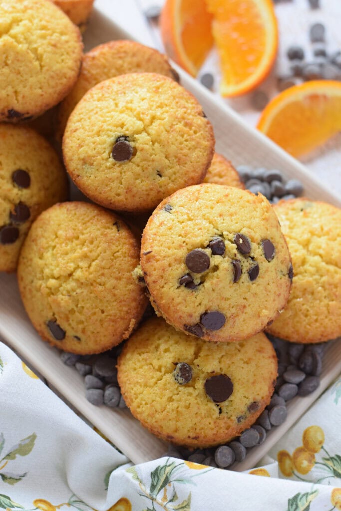 Orange chocolate chip muffins on a plate.