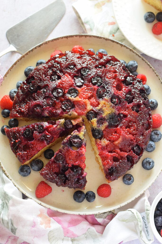 A berry upside down cake on a plate.