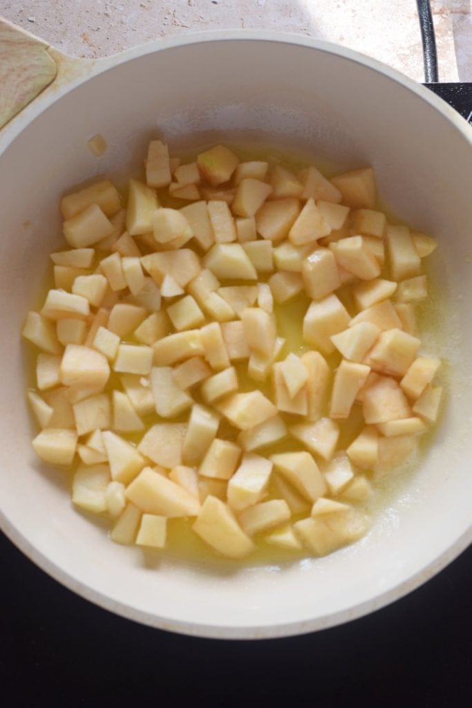 Apples in a white skillet.