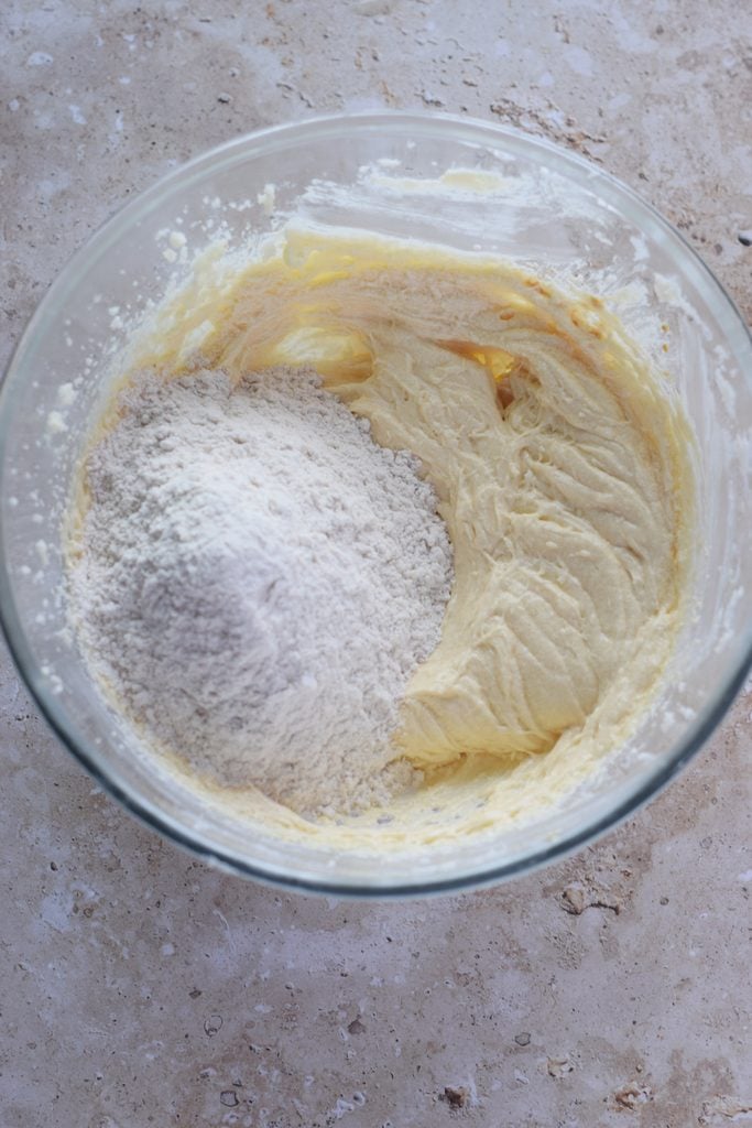 Adding flour to muffin batter.