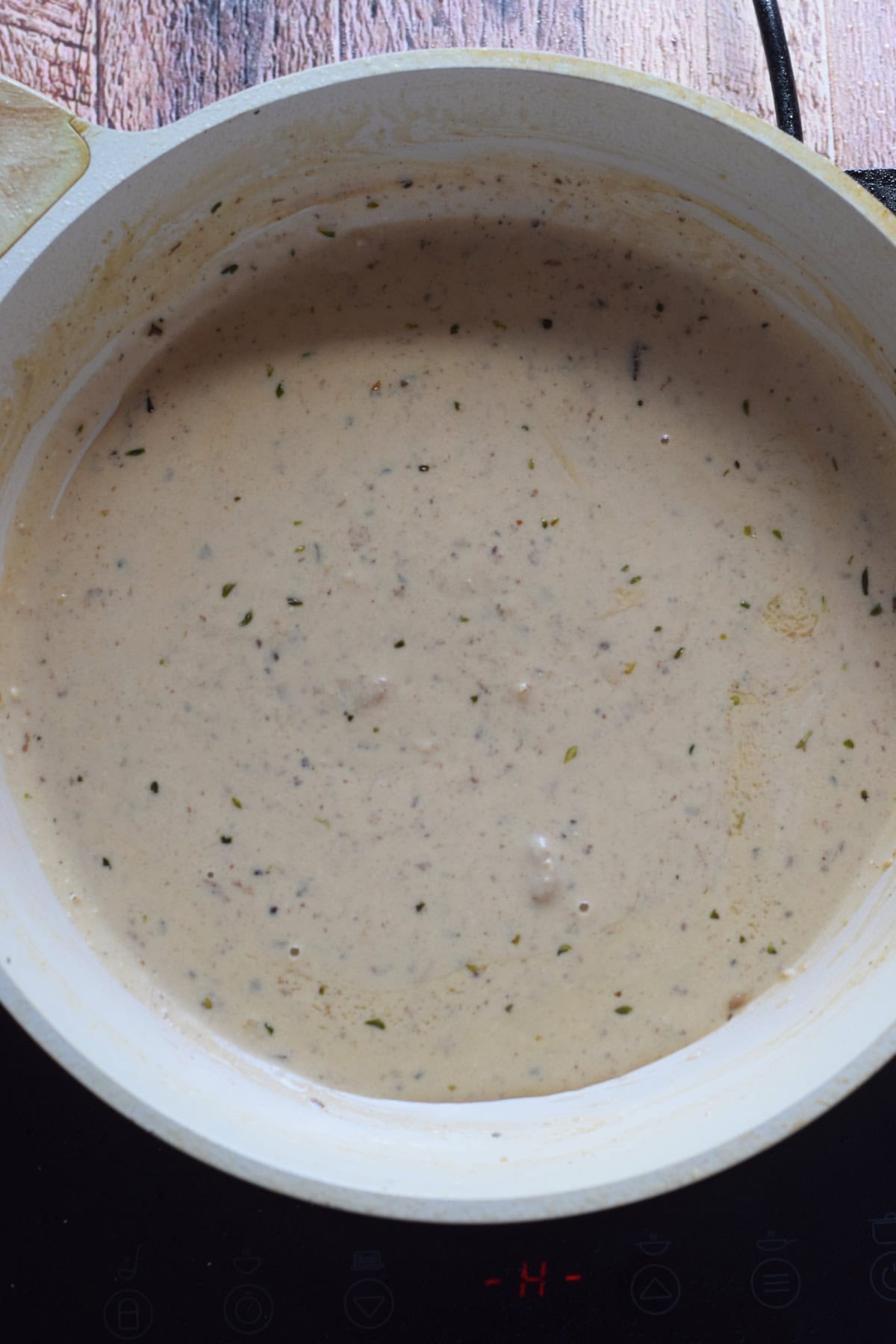 Cream wine sauce in a white skillet.