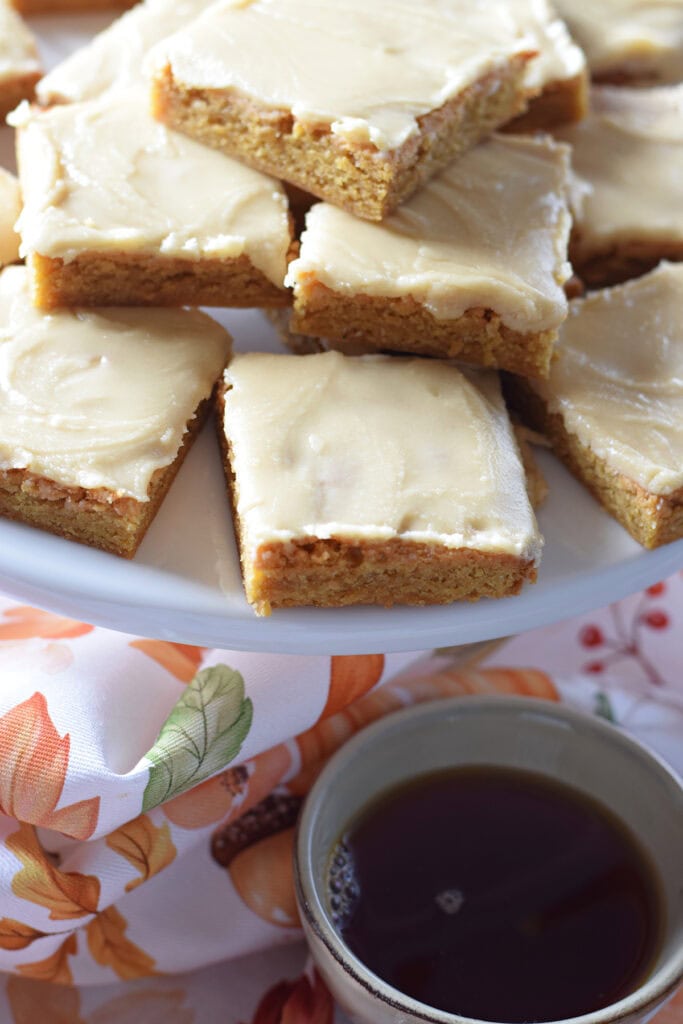 Blondies on a white serving plate.