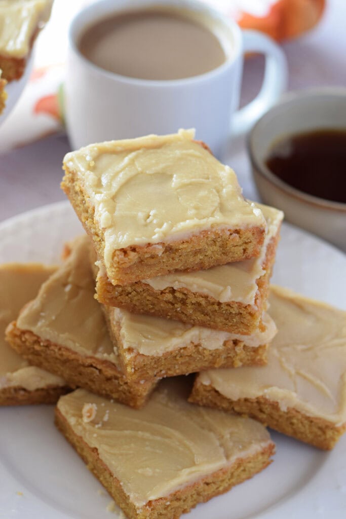 Blondies on a plate with a maple glaze.