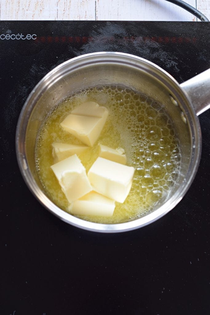 Adding butter to a saucepan.