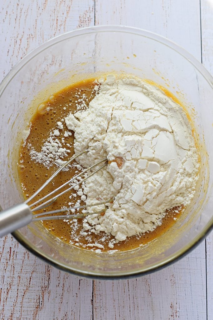 Adding flour to blondie batter.