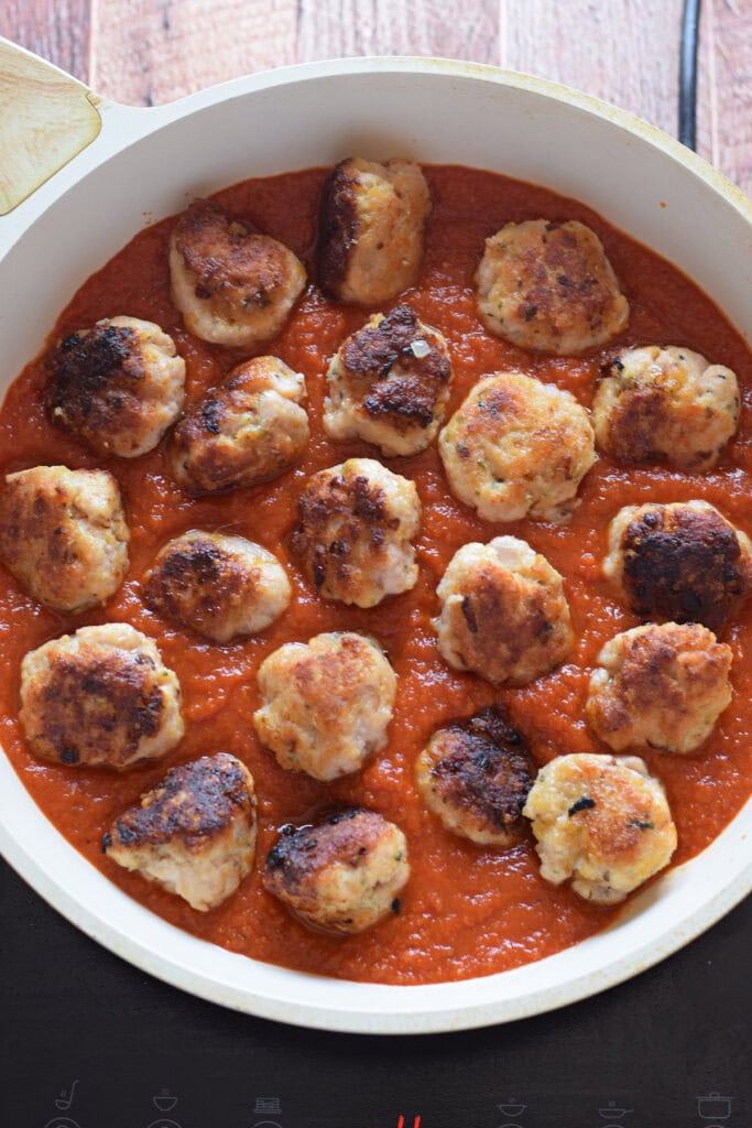 Cooking meatballs in a skillet.