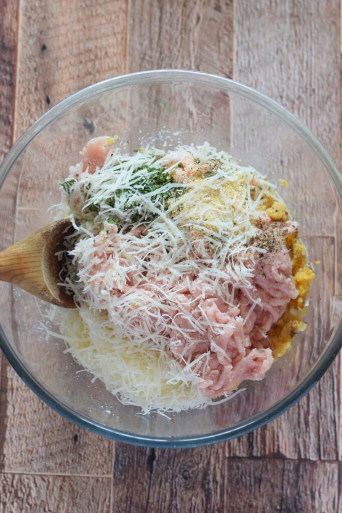 Making meatball mixture in a glass bowl.