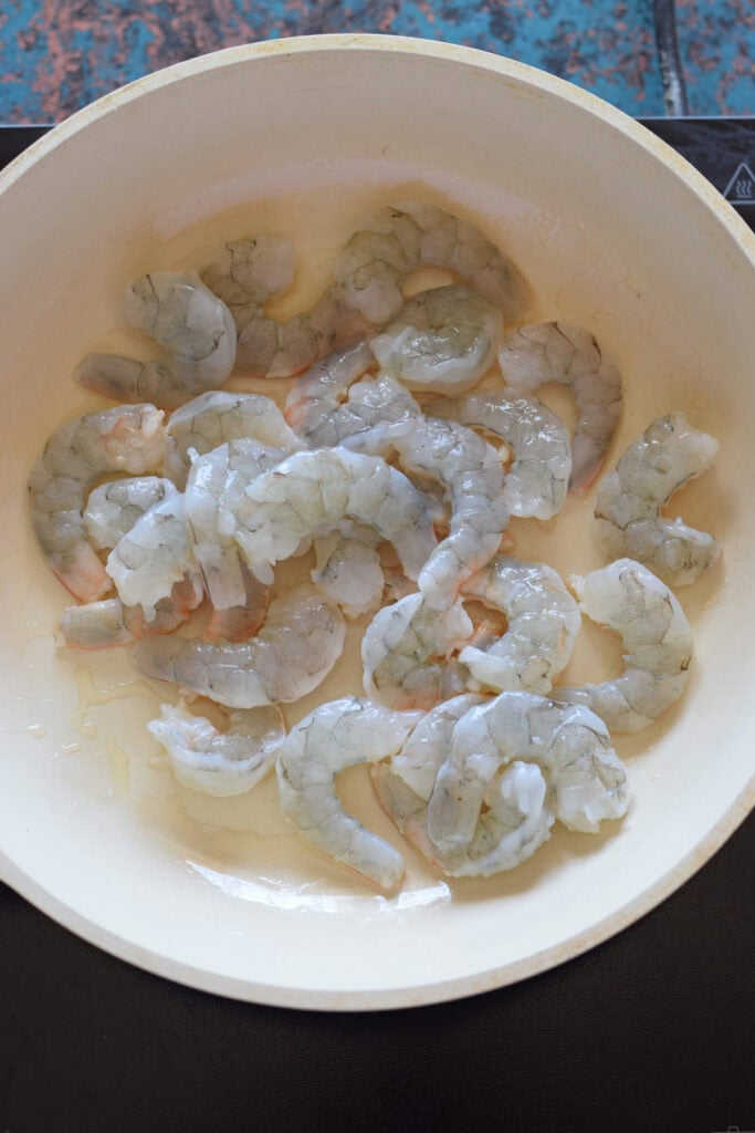 Add shrimp to a skillet.
