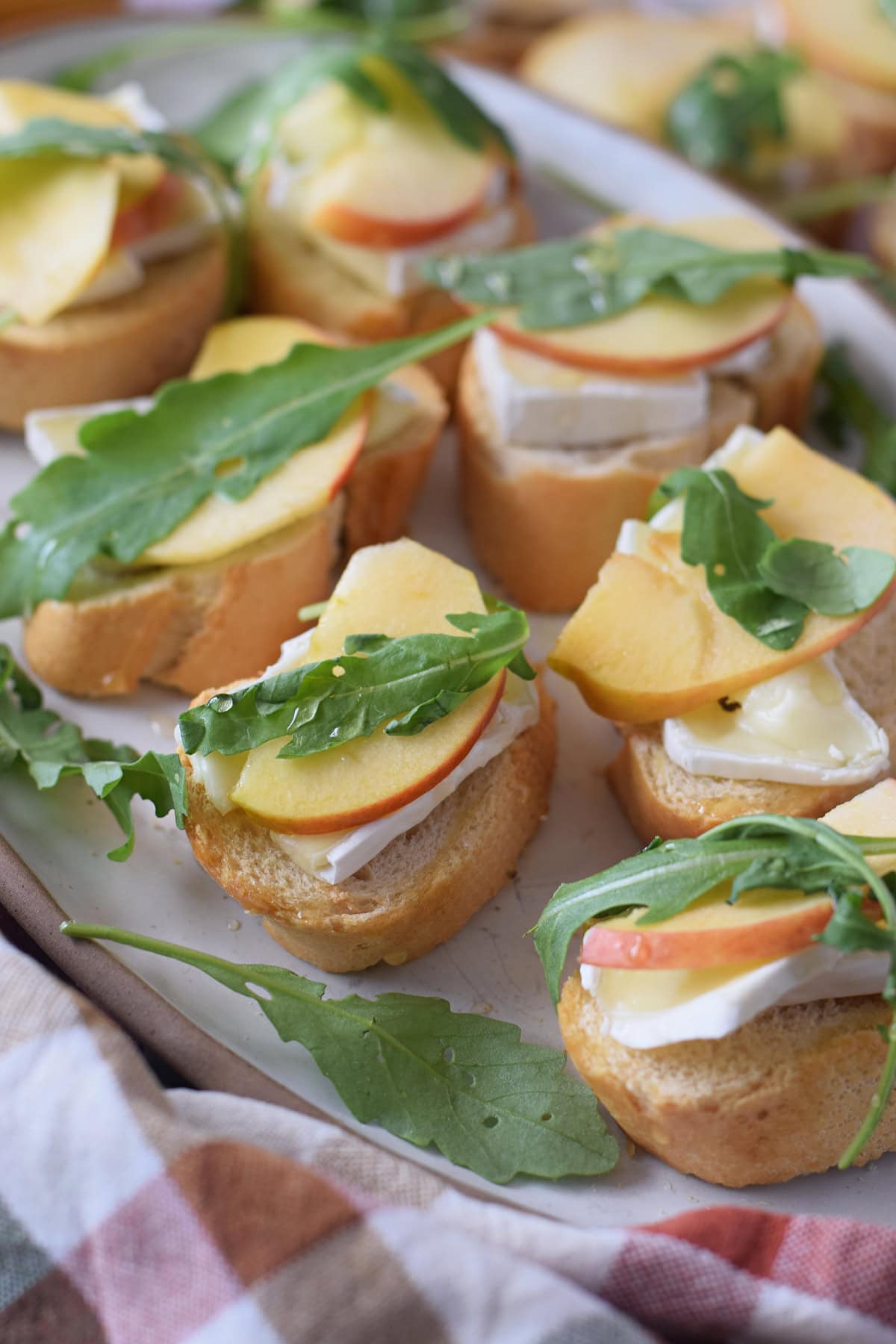 Close up of apple and brie crostini on a plate.