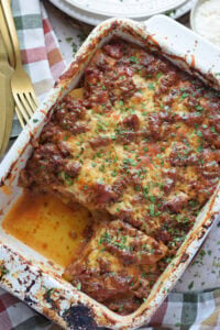 Casserole in a white dish with ground beef and potatoes.