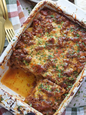 Casserole in a white dish with ground beef and potatoes.