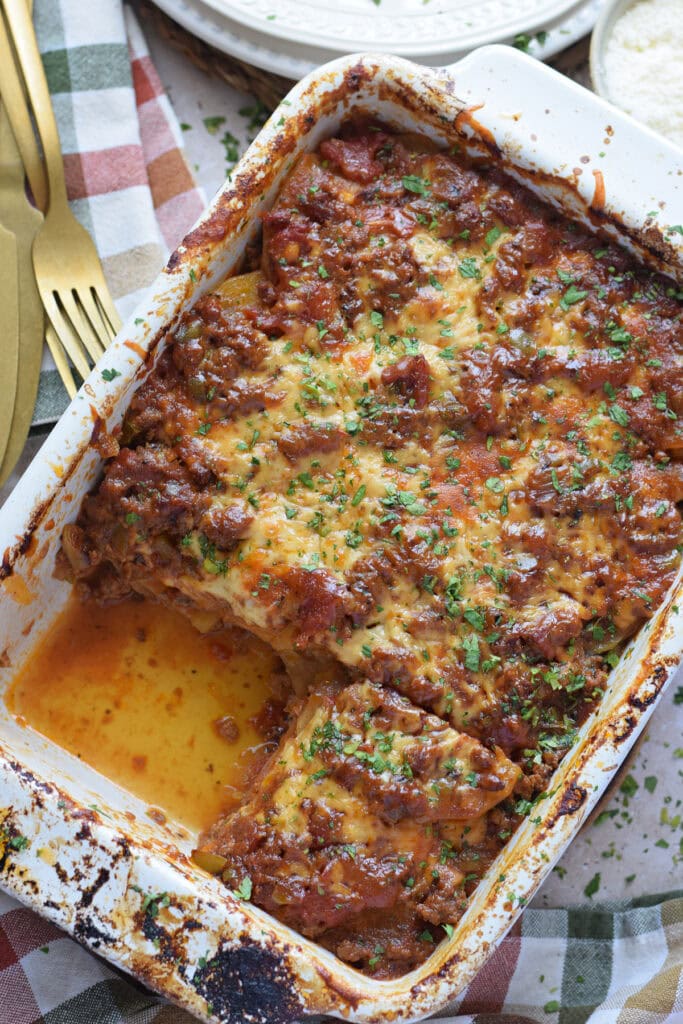 Casserole in a white dish with ground beef and potatoes.