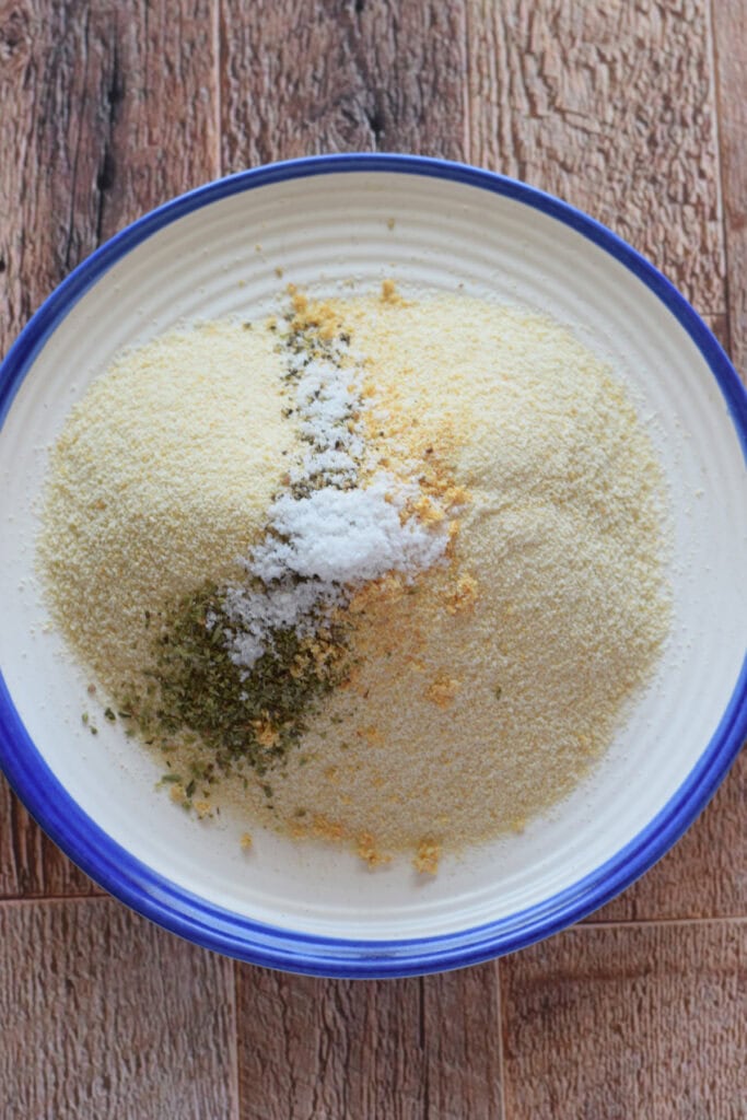 Bread crumbs with seasonings on a plate.
