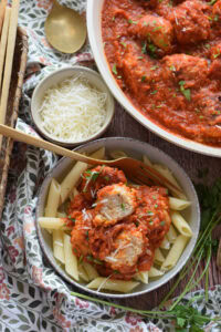 Meatballs in a tomato sauce with parmesan cheese.