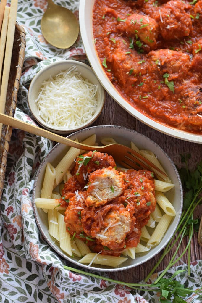 Meatballs in a tomato sauce with parmesan cheese.