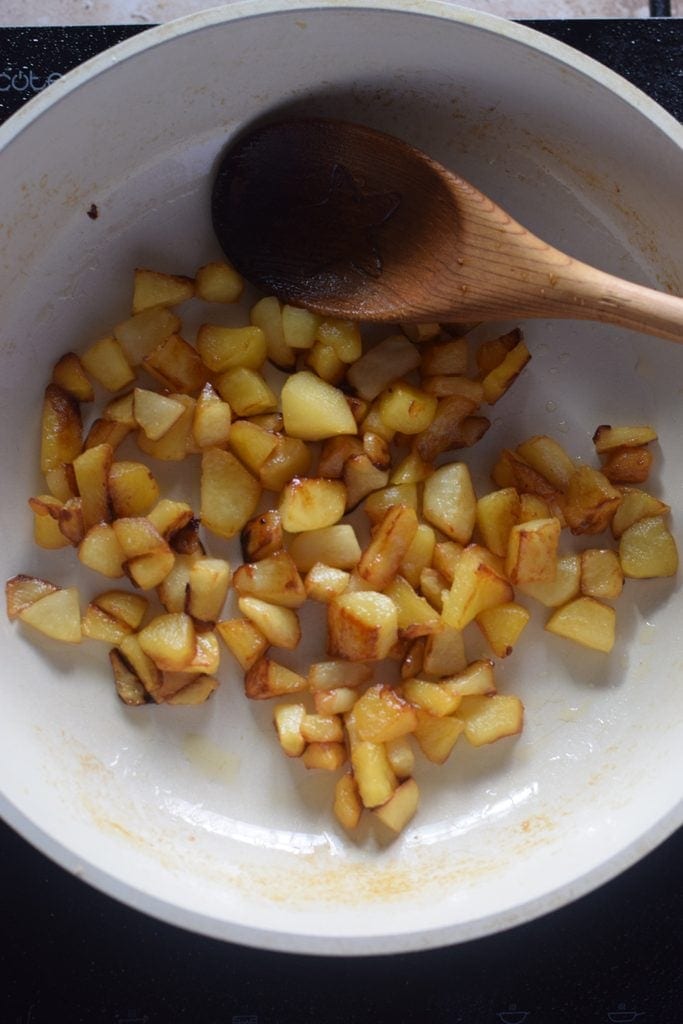 Cooked apples in a skillet.