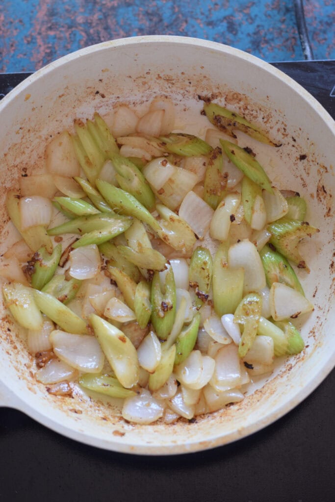 Cooked celery and onions in a skillet.