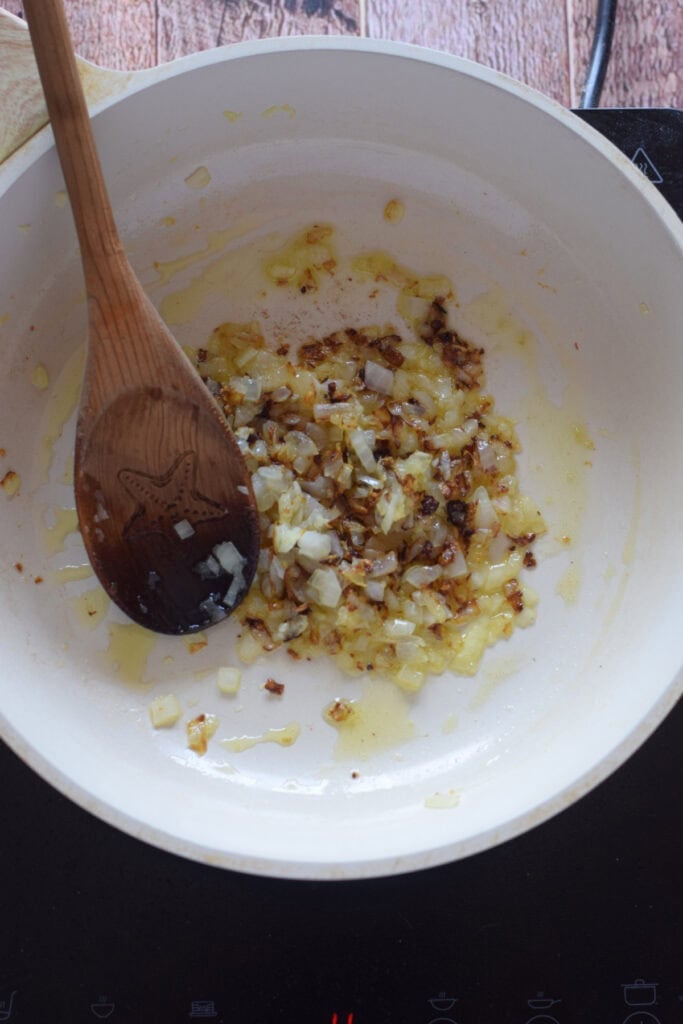 Cooking onions in a skillet.