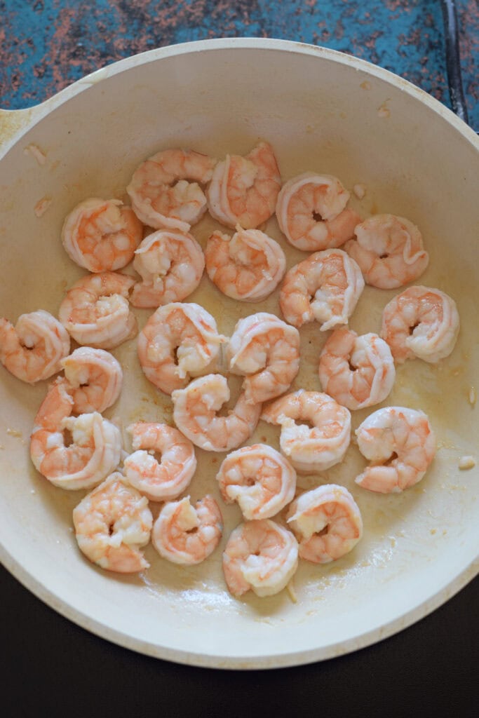 Cooked shrimp in a skillet.