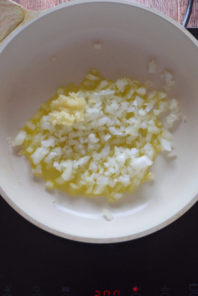 Onions and olive oil in a skillet.