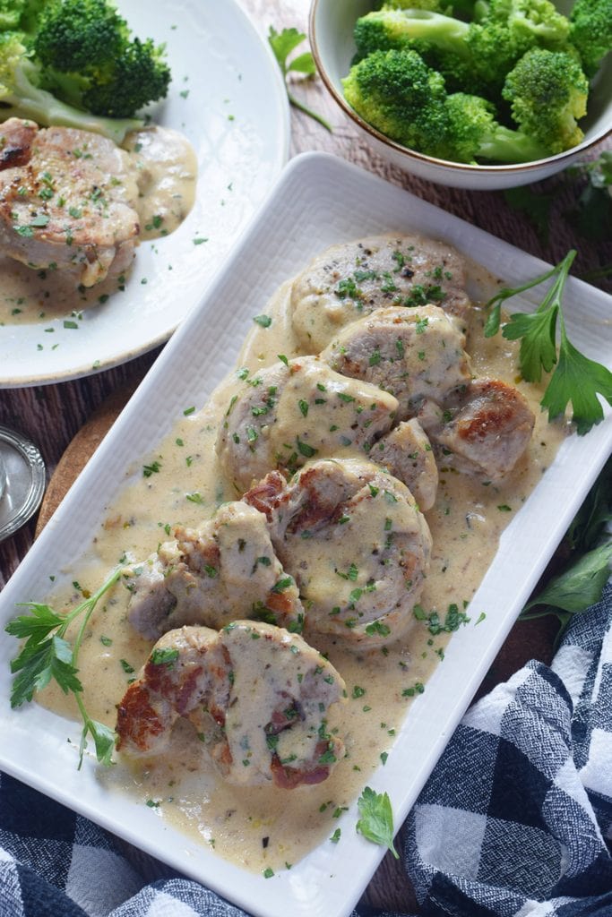 Pork on a white plate with sauce.