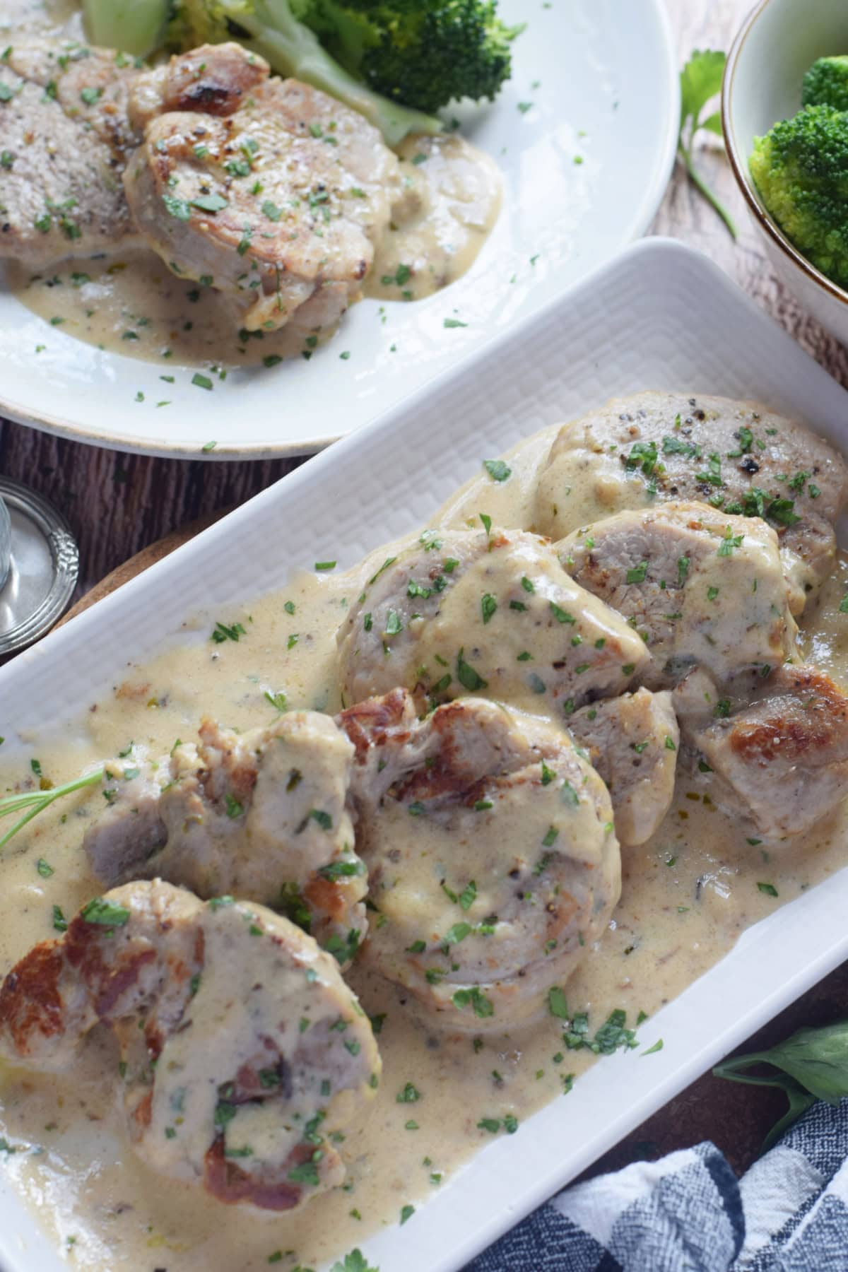 Pork medallions on a white plate.