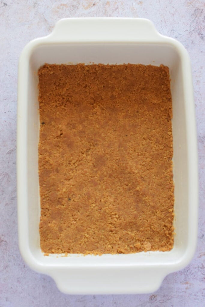 Cookie base in a ceramic baking dish.