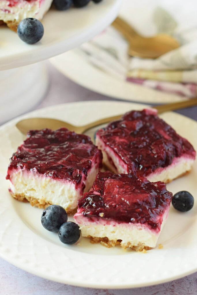 Cheesecake berry bars on a white plate.