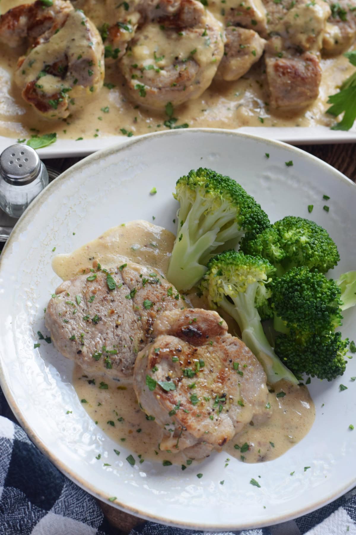 Pork on a plate with broccoli.