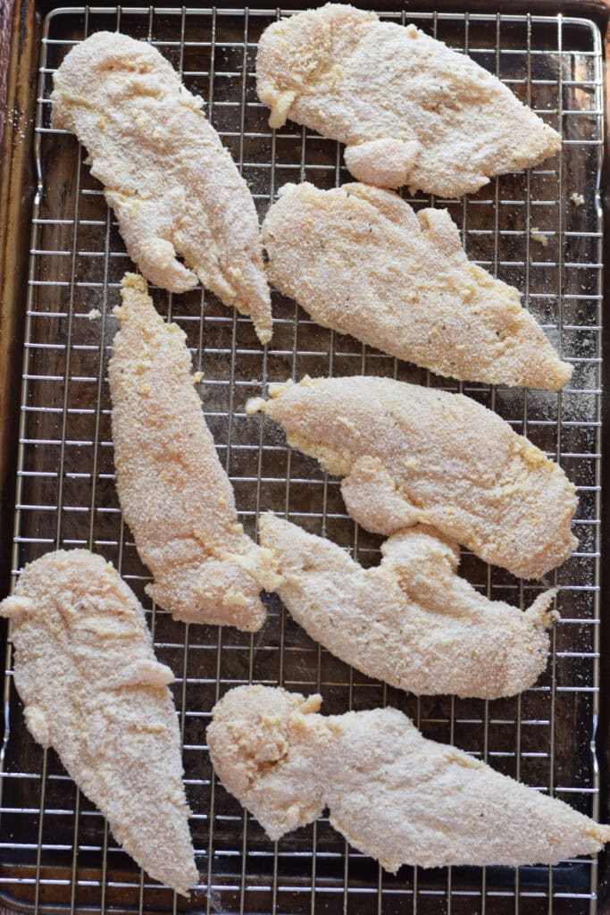 Ready to bake chicken on a baking tray.