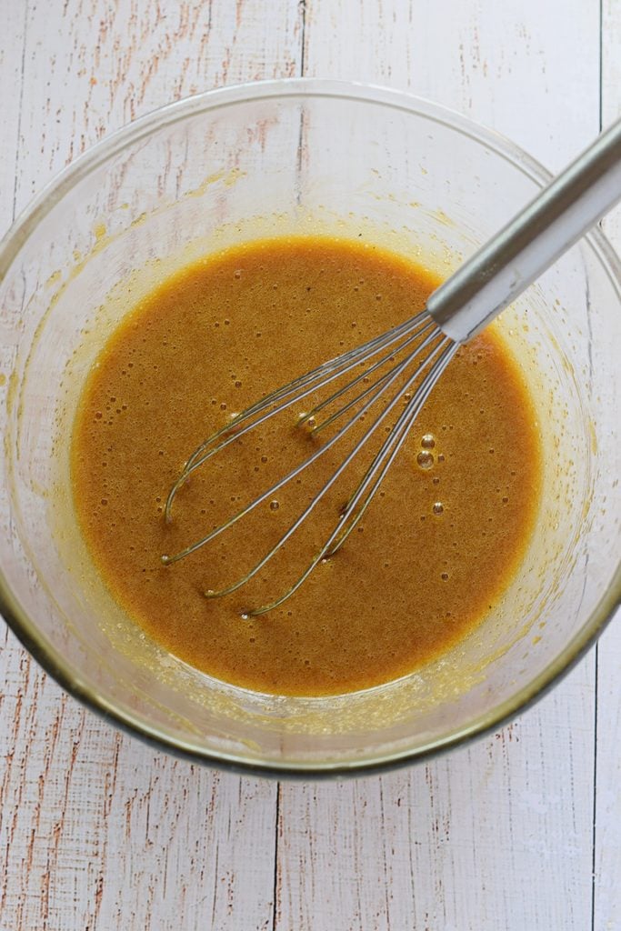 Adding eggs to blondie batter.