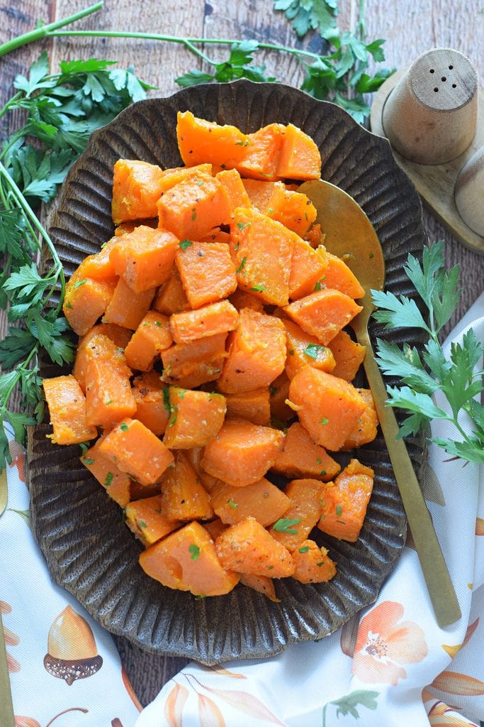 Roasted sweet potatoes on a wooden tray.