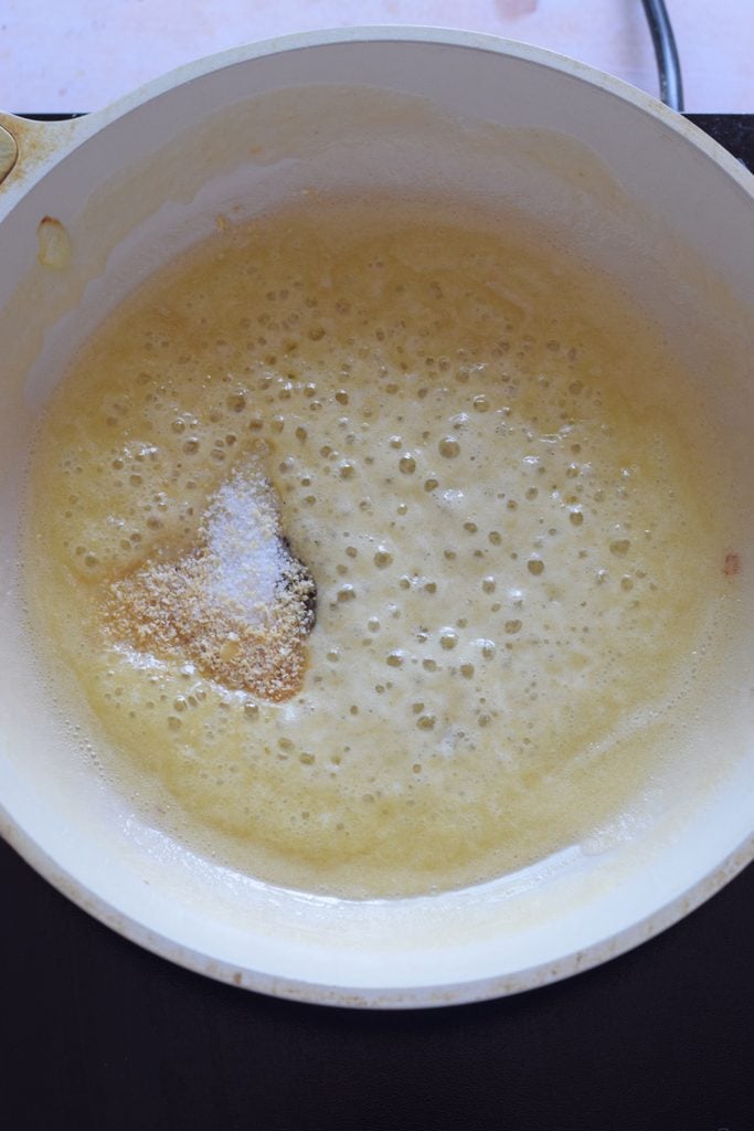 Adding seasonings to the skillet.