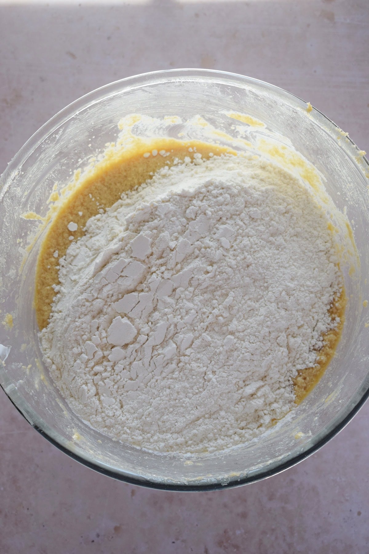 Adding flour to muffin batter.