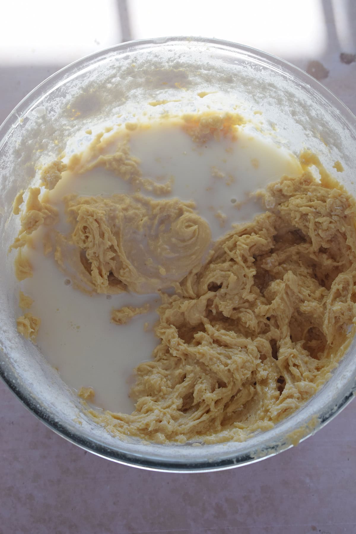 Adding milk to muffin batter.