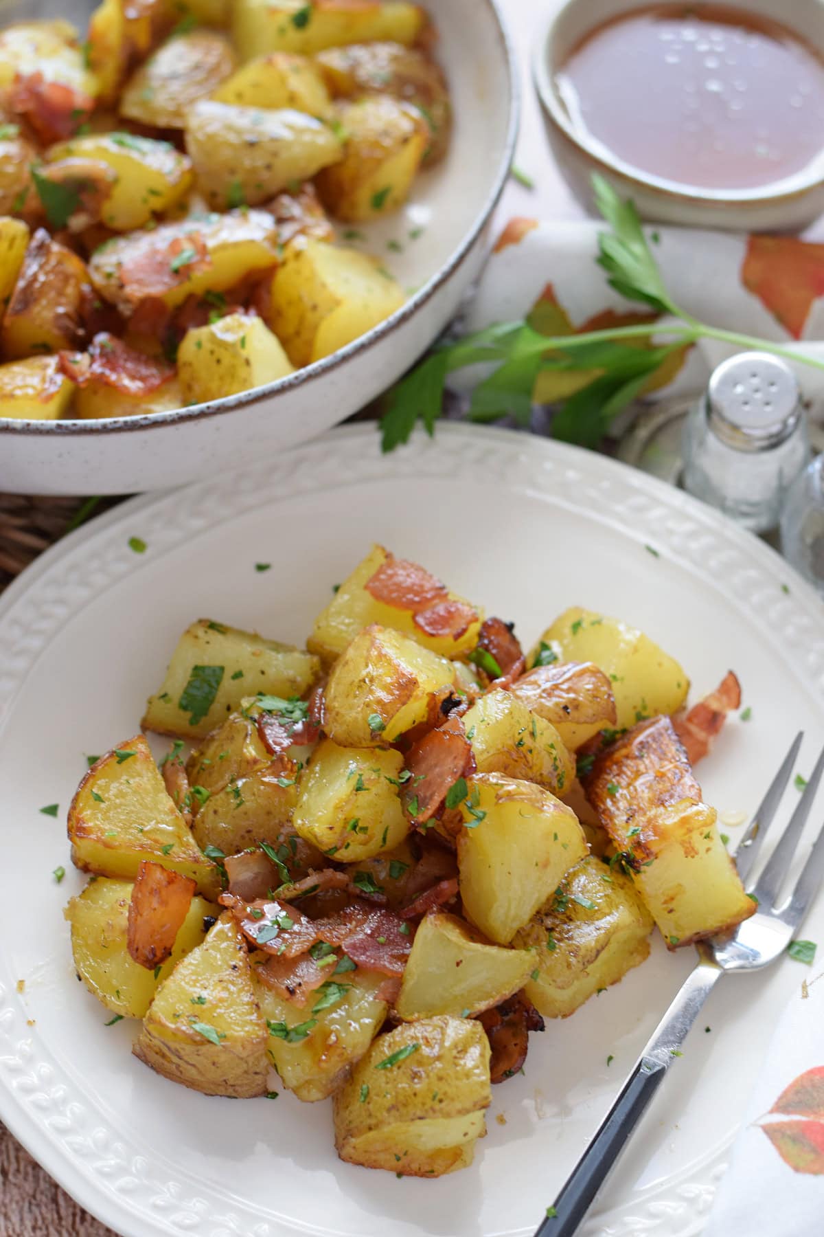 Bacon roasted potatoes on a white serving plate.