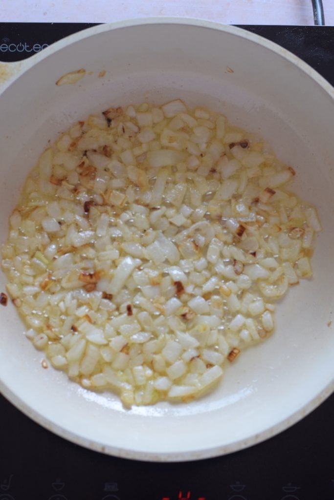 Sauteed onions in a skillet.