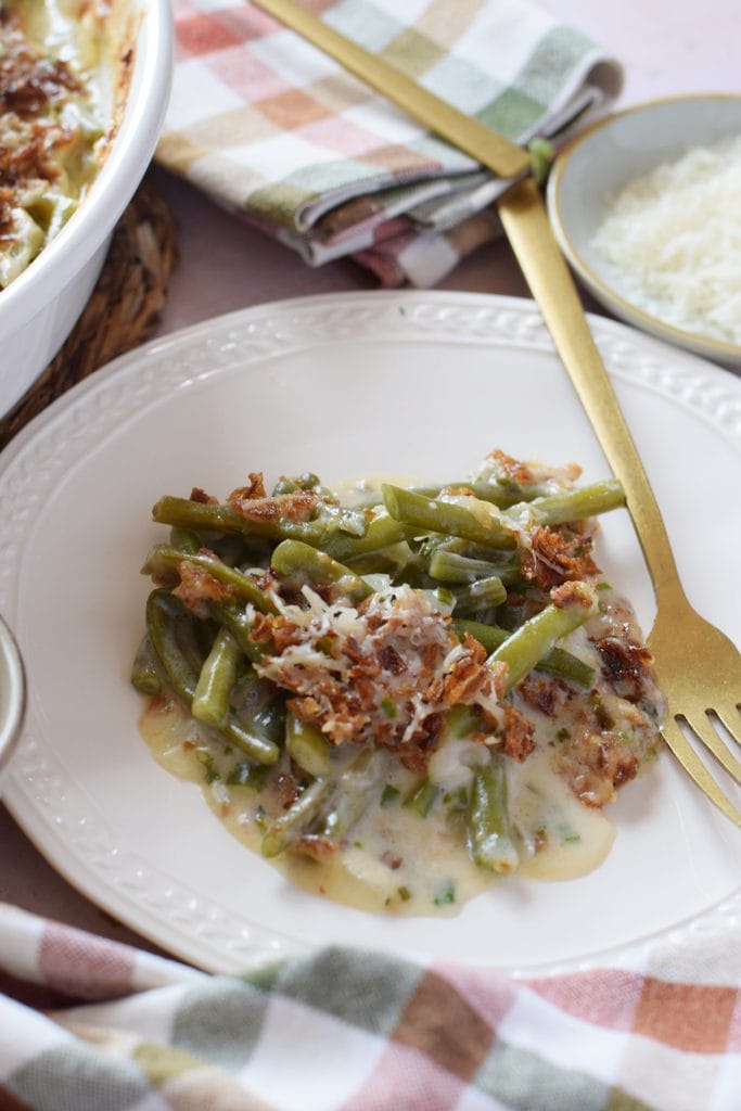 Casserole with green beans on a white plate.