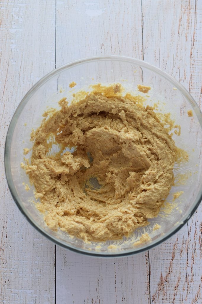 Mixed butter and sugar in a glass bowl.