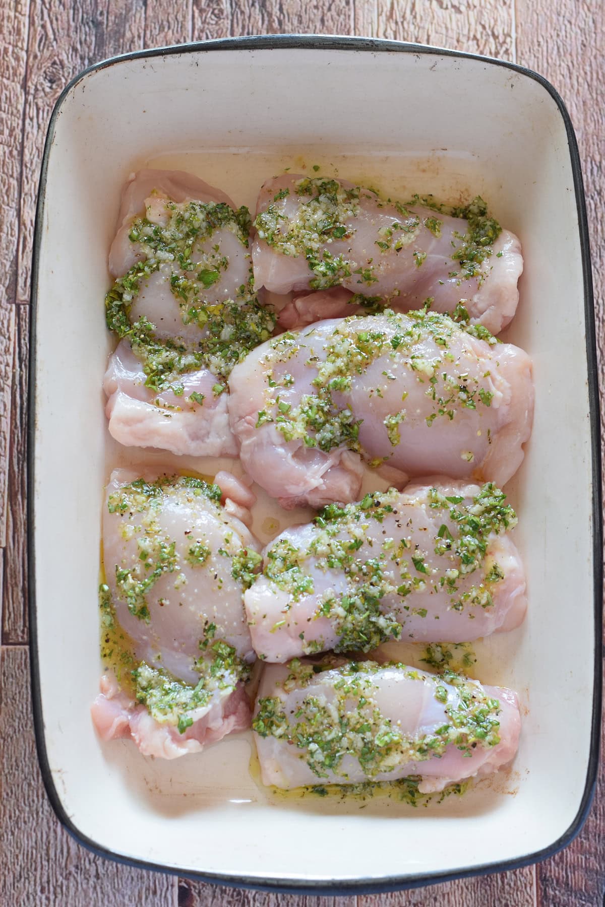 Marinaded chicken in a casserole dish.