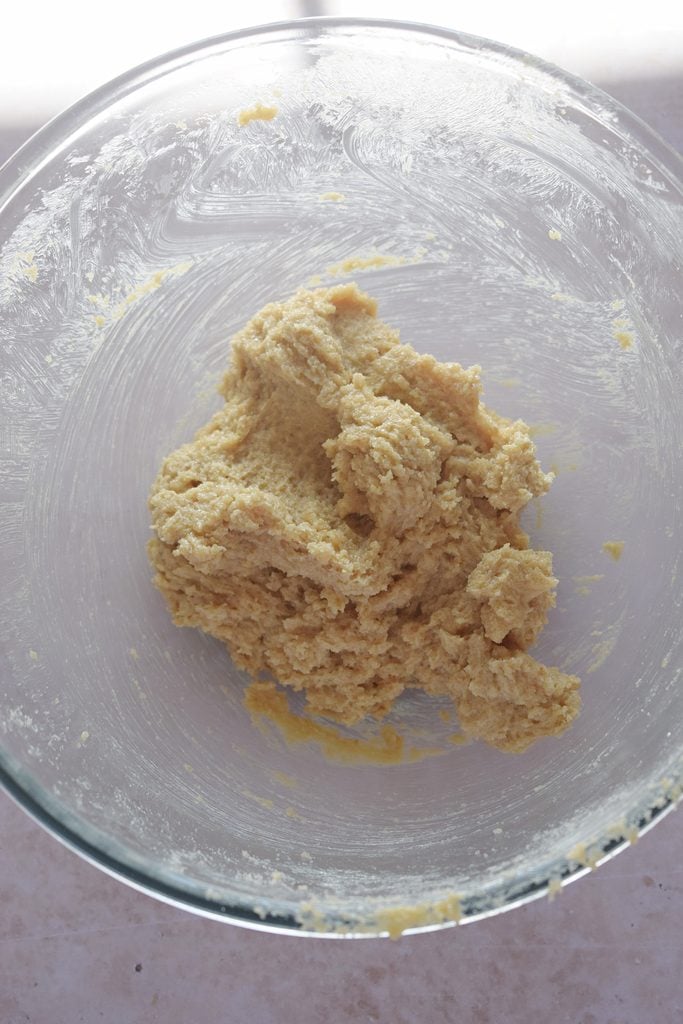 Mixed butter and sugar in a glass bowl.