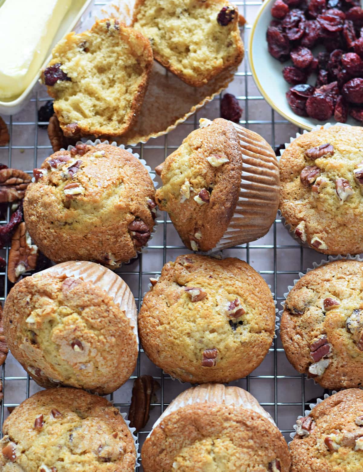 Cranberry and pecan muffins on a cooling rack.