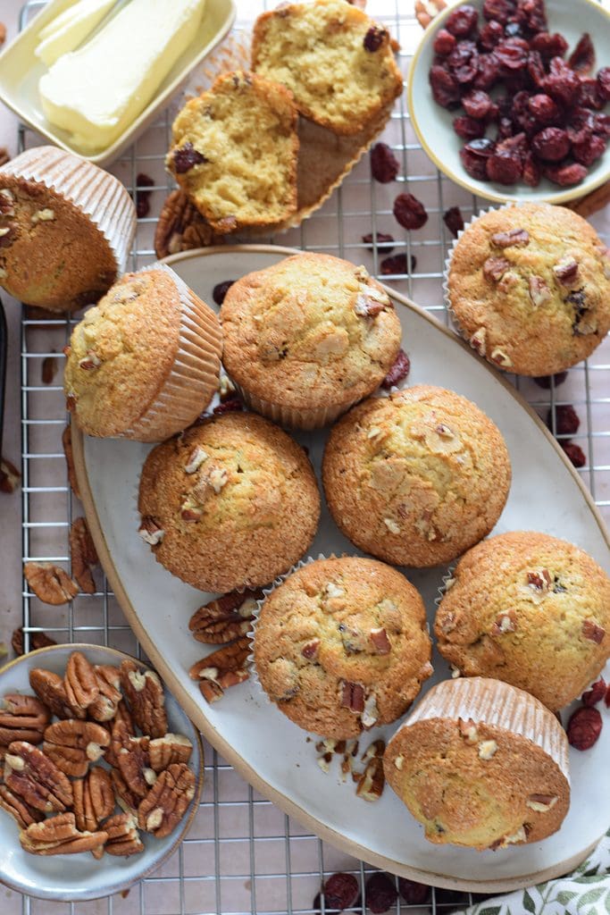 Cranberry and pecan muffins on a plate.