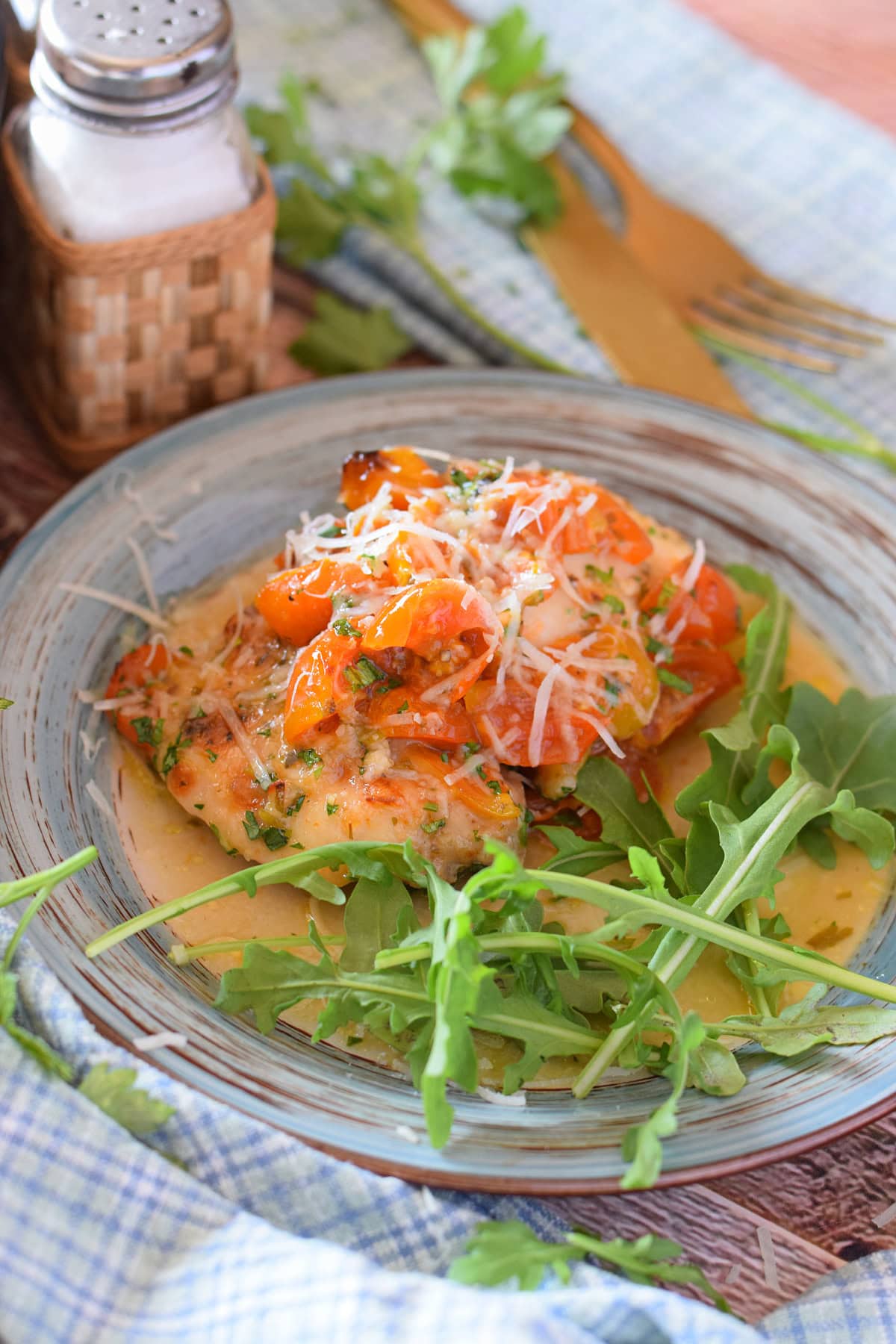 Baked tomato chicken on a plate.