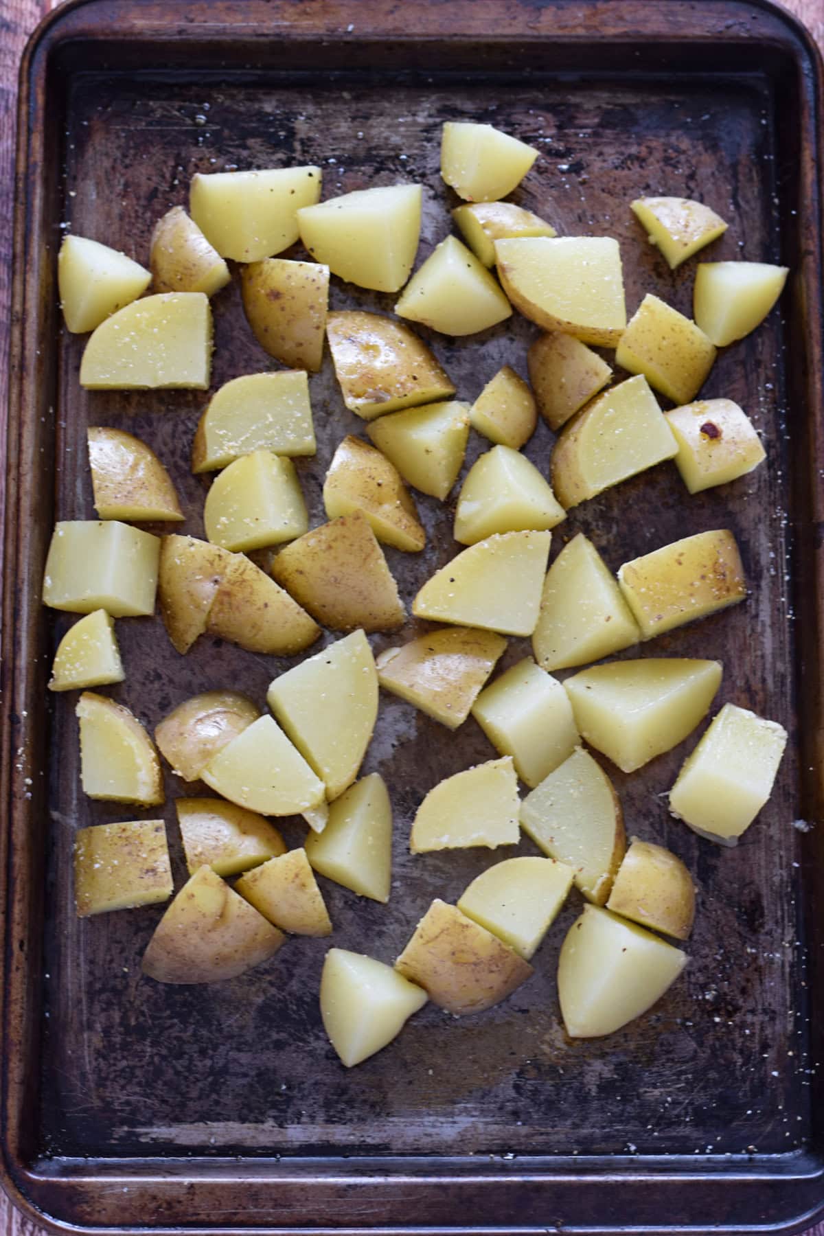 Ready to roast potatoes on a baking sheet.