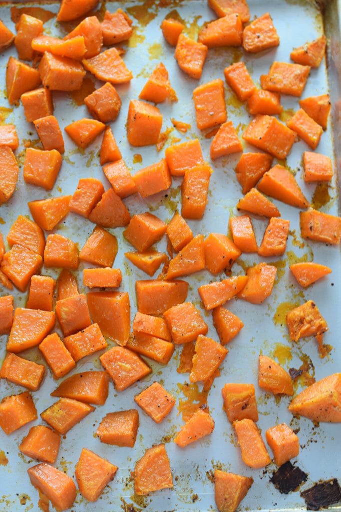 Roasted sweet potatoes on a baking tray.