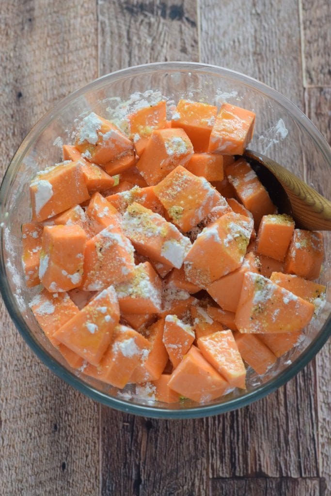 Sweet potatoes in a bowl with seasonings.